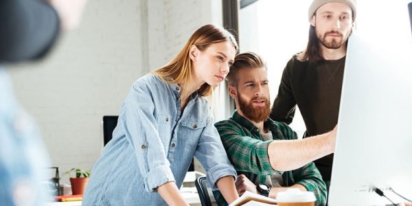 a group of people looking at a computer screen